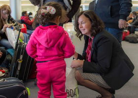 Canada's ambassador to Lebanon, Michelle Cameron, offers a teddy bear to a Syrian child at the beginning of an airlift of Syrian refugees to Canada, at the Beirut International airport December 10, 2015 in a photo provided by the Canadian military. REUTERS/Corporal Darcy Lefebvre/Canadian Forces Combat Camera/Handout via Reuters<br />
 <br/>