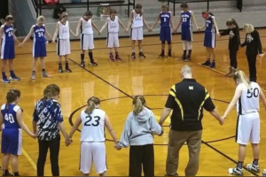 A basketball coach in Morristown, Ind., was asked to stop participating in prayer circles with his elementary girls' players after this photo from a Dec. 1 game surfaced. The legal director of the American Humanist Association says the coach's presence is 