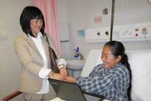 Christian Action executive director Cheung Ang Siew-mei holds on to Douge Zhuoma, who said she missed the children at the Qinghai orphanage and the food there while waiting to receive surgery. <br/>Christian Action 