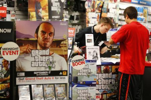 Game enthusiasts purchase the latest release of ''Grand Theft Auto Five'' after the game went on sale at the Game Stop store in Encinitas, California September 17, 2013. <br/>Reuters/Mike Blake