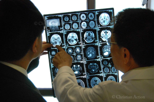 Doctors examine the MRIs of Douge Zhuoma. <br/>Christian Action 