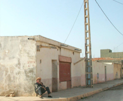 An Algerian man sits on a doorstep. <br/>Open Doors USA
