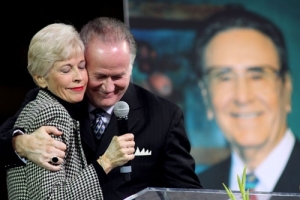 Roberta Potts and Richard Roberts share a tender moment as they eulogize their father, legendary evangelist Oral Roberts, at a Memorial and Celebration Service honoring his life and legacy on Monday, Dec. 21, 2009, in the Mabee Center on the campus of Oral Roberts University in Tulsa, Okla. <br/>Oral Roberts Evangelistic Association / Kelly Kerr
