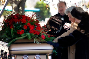 At a private graveside interment for their beloved patriarch, Oral Roberts, son Richard Roberts and his wife Lindsay; and daughter Roberta and her husband Ron Potts (couples pictured left to right), lay hands on their father’s casket in a prayer of thanksgiving for his life and legacy, Monday, Dec. 21, 2009. <br/>Oral Roberts Evangelistic Association / Kelly Kerr