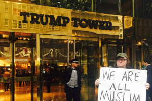 American documentary film maker, author and political activist Michael Moore stood in front of Trump Tower Wednesday with a sign that read 