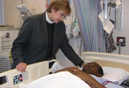 The Rev. Babs M. Meairs, director of the Chaplain Service at the VA San Diego Healthcare System, checks on a patient in this undated file photo. <br/>