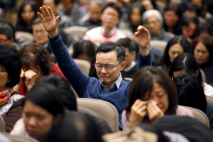 <br />
Jae Sun Lee of North York raises his hands while praying for Canadian pastor Hyeon Soo Lim who is being held in North Korea during a joint multi-cultural prayer meeting at Light Korean Presbyterian Church in Toronto, December 20, 2015. <br/> REUTERS/Hyungwon Kang