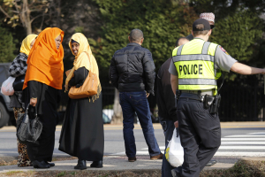 A Fairfax County police officer controls traffic as women make their way to the Dar Al-Hijrah Islamic Center in Falls Church, Virginia just outside of Washington December 11, 2015. <br/>Reuters