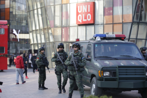 Armed policemen of the Snow Leopard Commando Unit (C) stand guard near a police van at the Sanlitun area, a fashionable location for shopping and dining, in Beijing, China, December 24, 2015. <br/>Reuters