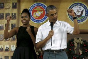 U.S. President Barack Obama and first lady Michelle Obama gesture as they arrive to deliver remarks at a Christmas reception with service members at Marine Corps Base Hawaii in Kaneohe Bay, Hawaii December 25, 2015.  <br/>Reuters