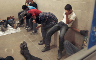 Immigrants who have been caught crossing the border illegally are housed inside the McAllen Border Patrol Station in McAllen, Texas, in this file photo taken July 15, 2014. <br/> REUTERS/ Rick Loomis/Pool/Files
