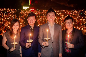 City Harvest Church pastor Kong Hee pictured with several church members during the annual candlight service <br/>Facebook