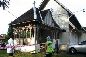 Police officers inspect damage at the All Saints Church in Taiping of Perak state, Malaysia, Sunday, Jan. 10, 2010. Another church was hit by a firebomb early Sunday, the fifth assault in three days of unrest following a court decision that allows Christians and other non-Muslims to use 'Allah' to refer to God. <br/>AP 