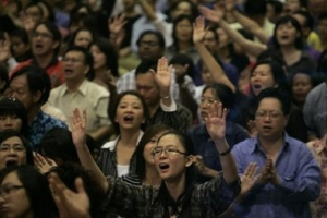 Christian devotees sing songs during a Sunday service at the meeting hall of the Malaysian Chinese Association party in Kuala Lumpur, Malaysia, Sunday, Jan. 10, 2010. On Sunday, men, women and children from the Metro Tabernacle parish, whose parish church was partly gutted in last week's firebomb attack, assembled at the makeshift prayer hall for their Sunday service and called for national unity and an end to violence. <br/>AP Photo / Lai Seng Sin