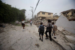 People walk through the streets after a powerful earthquake struck Port-au-Prince, Tuesday, Jan. 12, 2010. <br/>AP Images / Cris Bierrenbach