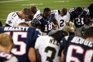 New England Patriots wide receiver Matthew Slater (18) leads members of his team and the New Orleans Saints in prayer after their NFL pre-season game in Foxboro, Massachusetts, August 9, 2012. REUTERS/Dominick Reuter <br/>