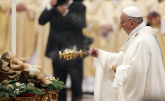 Pope Francis spreads incense in front of a statue of baby Jesus as he leads a mass on New Year's Day at Saint Peter's Basilica at the Vatican Jan. 1, 2016.  <br/>REUTERS/Giampiero Sposito