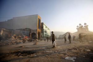 People walk on a street in downtown Port-au-Prince, Sunday, Jan. 17, 2010, five days after a powerful earthquake hit Haiti. <br/>AP