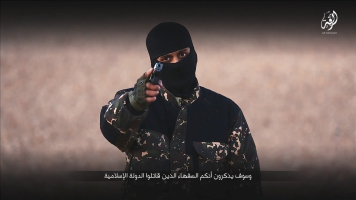 A masked man points a weapon as he speaks in this still image from a handout video obtained on January 4, 2016 from a social media website which has not been independently verified.  <br/>REUTERS/Social Media via Reuters
