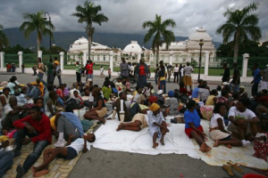Survivors camp gather outside Haiti's National Palace, which was damaged by an earthquake in Port-au-Prince, Haiti, Wednesday, Jan. 13, 2010 <br/>AP