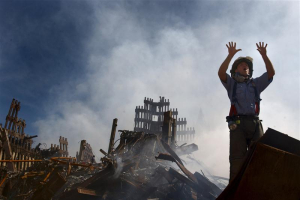 A New York City fireman calls for more rescue workers to make their way into the rubble of the World Trade Center September 15, 2001. REUTERS/HO/U.S. Navy Photo by Journalist 1st Class Preston Keres <br/>