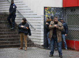 <br />
French police check a pedestrian as they secure the area after a man was shot dead at a police station in the 18th district in Paris, France January 7, 2016.  <br/>Reuters