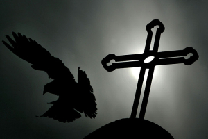 A pigeon flies past a metal cross at a Catholic church in Beijing April 7, 2005. Reuters <br/>
