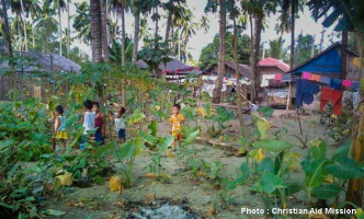 Children in a remote area of Mindanao, Philippines helped gather coconut leaves for a church building that was destroyed by arson on Christmas Eve. <br/>Christian Aid Mission
