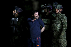 Joaquin 'El Chapo' Guzman is escorted by soldiers during a presentation at the hangar belonging to the office of the Attorney General in Mexico City, Mexico January 8, 2016. Reuters/Edgard Garrido <br/>