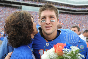 In this Nov. 28, 2009, file photo, Florida quarterback Tim Tebow embraces his mother, Pam, during a pre-game ceremony for graduating seniors on the Florida football team prior to an NCAA college football game against Florida State in Gainesville, Fla. CBS responded to complaints over a conservative group's planned Super Bowl ad featuring football star Tim Tebow and his mother Pam by saying that it had eased restrictions on advocacy ads and would consider <br/>AP Photo / Phil Sandlin, Pool, File