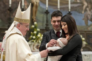 Pope Francis baptises one of 32 babies during a mass in the Sistine Chapel at the Vatican January 12, 2014, in this handout courtesy of Osservatore Romano. <br/>Reuters/ Osservatore Romano.