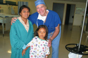 Dr. Paul Church with a young girl who he operated on while on a medical mission trip in Mexico. Courtesy of Dr. Paul Church <br/>