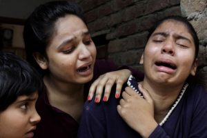 Pakistani Christian girls mourn over a family member who was killed from a suicide bombing attack. <br/>Reuters