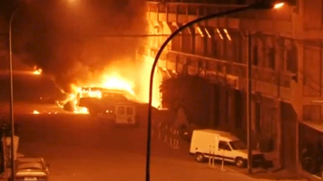 A view shows vehicles on fire outside Splendid Hotel in Ouagadougou, Burkina Faso in this still image taken from a video January 15, 2016, during a siege by Islamist gunmen. REUTERS/Reuters TV <br/>