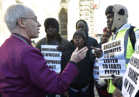 The Archbishop of Canterbury Justin Welby (L) speaks with protestors in the grounds of Canterbury Cathedral in Canterbury, southern Britain January 15, 2016. <br/> REUTERS/Toby Melville