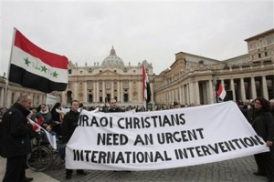 Iraqi faithful hold a banner prior to the start of Pope Benedict XVI's Angelus prayer in St. Peter's square, at the Vatican, Sunday, Feb. 28, 2010. The Pontiff appealed to the Iraqi authorities to provide security to Christians minority following the recent spate of killings against Christians in Iraq. <br/>AP Images / Gregorio Borgia