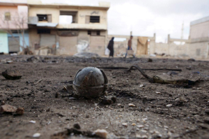 An unexploded cluster bomblet is seen along a street after airstrikes by pro-Syrian government forces in the rebel held al-Ghariyah al-Gharbiyah town, in Deraa province, Syria February 11, 2016. REUTERS/Alaa Al-Faqir <br/>