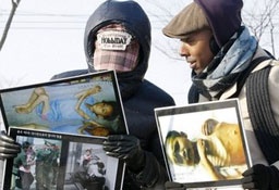 In this photo taken on Jan. 12, 2010, American Aijalon Mahli Gomes, right, whose identification was made by Seoul-based activist Jo Sung-rae, talks with an unidentified South Korean activist during a rally organized by Jo denouncing North Korean's human rights conditions at the Imjingak Pavilion, near the demilitarized zone (DMZ) of Panmunjom that separates the two Koreas since the Korean War, in Paju, South Korea. <br/>AP Images / Ahn Young-joon