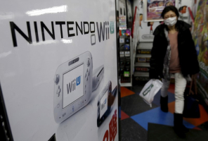 A woman walks past an advertisement board of Nintendo Co Ltd's Wii U game console at an electronics retail store in Tokyo, Japan, February 2, 2016. REUTERS/Yuya Shino <br/>