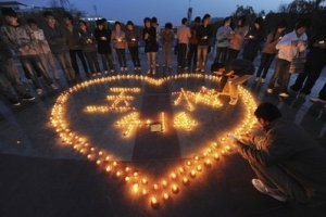 University students participate in a candlelight vigil in memory of the victims of the Yushu Earthquake in Hefei in central China's Anhui province, Friday April 16, 2010. Rescuers probed the rubble for sounds or movement Friday in a rush to find anyone buried alive more than 48 hours after an earthquake hit western China, killing at least 760 people. <br/>AP Photo
