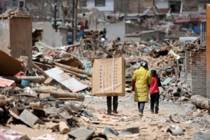 In this photo released by China's Xinhua News Agency, a family brings relief supplies to home in quake-hit Yushu County, northwest China's Qinghai Province, Sunday, April 18, 2010. <br/>AP Photo/Xinhua, Nie Jianjiang