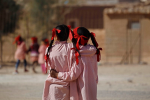 Indigenous Sahrawi girls hug each other beside their school in a refugee camp of Boudjdour in Tindouf, southern Algeria March 3, 2016. <br/> REUTERS/Zohra Bensemra