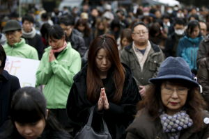 Participants observe a moment of silence at 2:46 p.m. (0546 GMT), the time when the magnitude 9.0 earthquake struck off Japan's coast in 2011, during a rally in Tokyo, March 11, 2016, to mark the fifth-year anniversary of the earthquake and tsunami that killed thousands and set off a nuclear crisis. <br/>