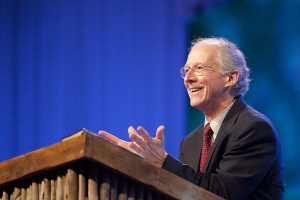 Photo of John Piper, theologian, preaching from a pulpit. Wikimedia Commons/Micah Chiang <br/>