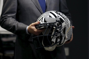 A representative holds a new impact absorbing helmet at the NFL Headquarters in New York December 3, 2015. REUTERS/Brendan McDermid <br/>REUTERS/Brendan McDermid