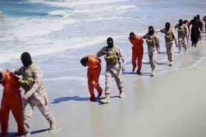 Islamic State militants lead what are said to be Ethiopian Christians along a beach in Wilayat Barqa, in this still image from an undated video made available on a social media website on April 19, 2015. Photo Credit: REUTERS/Social Media Website via Reuters TV <br/>