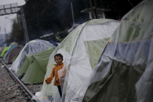 A child stands at the entrance of a tent at a makeshift camp for refugees and migrants at the Greek-Macedonian border, near the village of Idomeni, Greece March 15, 2016. Photo Credit:REUTERS/Alkis Konstantinidis <br/>