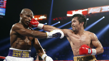 Manny Pacquiao (right), of the Philippines, hits Timothy Bradley Jr. during their WBO welterweight title boxing bout on Saturday in Las Vegas. Photo Credit: Isaac Brekken/AP <br/>