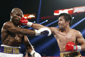 Manny Pacquiao (right), of the Philippines, hits Timothy Bradley Jr. during their WBO welterweight title boxing bout on Saturday in Las Vegas. Photo Credit: Isaac Brekken/AP <br/>