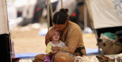 A woman who fled the Islamic State's strongholds of Hawija and Mosul, cares for her baby at a camp for displaced people in Daquq, Iraq,  <br/>Reuters